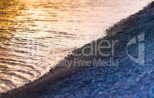 Horizontal pebble beach sunset landscape bokeh background backdr