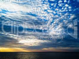 Horizontal vibrant ocean horizon cloudscape background backdrop