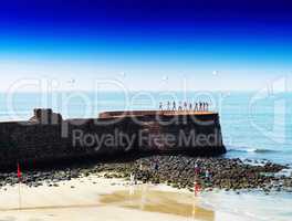 Horizontal vivid Indian castle wall beach with parachutes backgr