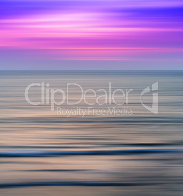 Vertical vivid vibrant pink ocean sunset landscape motion blur a