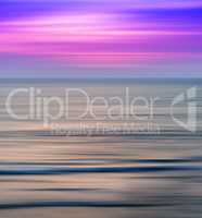 Vertical vivid vibrant pink ocean sunset landscape motion blur a