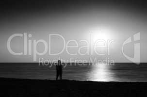Horizontal vivid black and white meeting ocean sunset lonely man