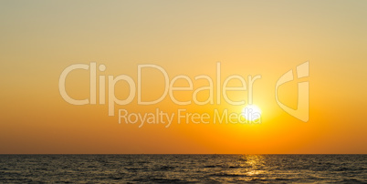 Horizontal vibrant orange ocean sunset background backdrop