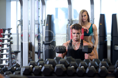 Man exercising and his girlfriend supports him