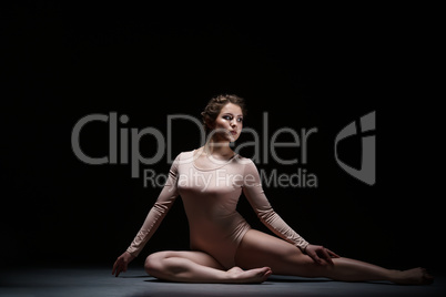 Sport. Charming artistic gymnast posing in studio