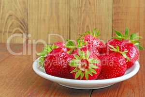 ripe red strawberries on the plate