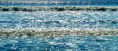 Horizontal wide tidal ocean waves bokeh background backdrop