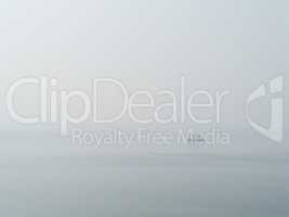 Horizontal sparse pale lonely ship in white ocean background bac