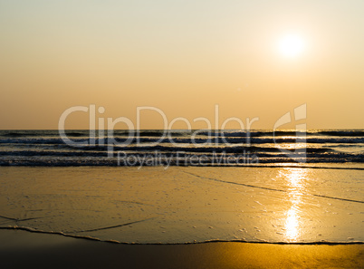 Horizontal vivid golden tidal waves with sun reflection backgrou