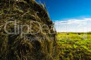 Horizontal vibrant summer hay stack sun background backdrop