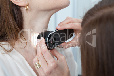 Doctor examining birthmarks and moles on a female patient