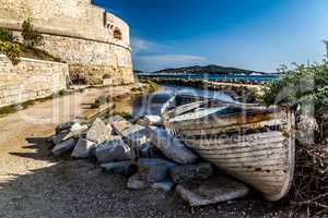 aged and abandoned fishing boats laying on the shore