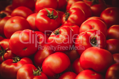 Fresh organic tomatoes at market background texture