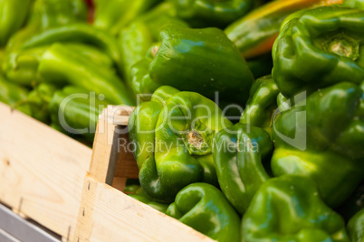 Green pepper in a wood basket at market