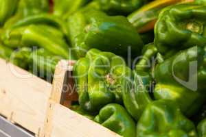 Green pepper in a wood basket at market