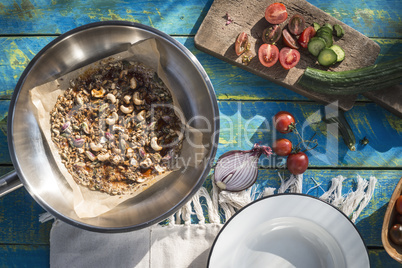 Salad with tomatoes, cucumber, onion and caramelized nuts.