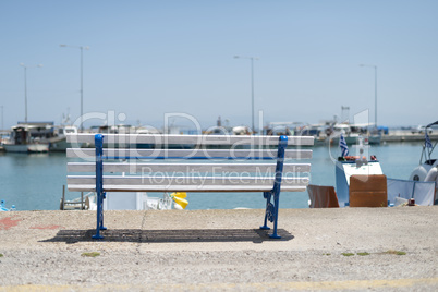 Bench on the beach and boats