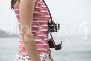 Woman with vintage camera on the beach