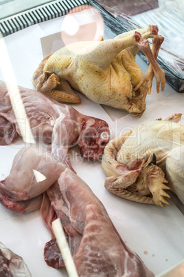 Chickens and rabbits in a butcher shop