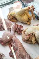 Chickens and rabbits in a butcher shop