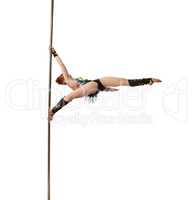 Pretty female gymnast performs trick on pylon