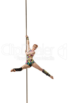 Red-haired woman posing while dancing on pylon