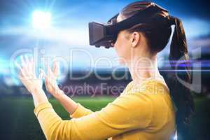 Composite image of woman using an oculus