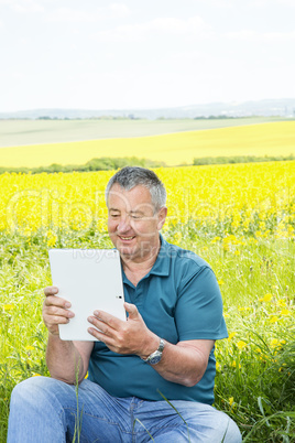 Man with tablet PC on the field