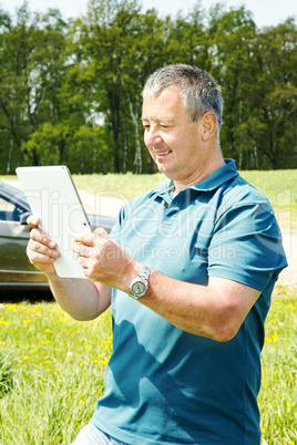 Man with Tablet PC and car