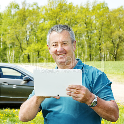 Man with Tablet PC and car