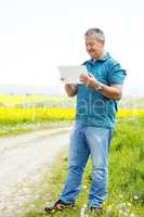 Man with tablet PC on the field