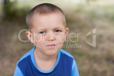 Portrait of a boy close up in nature