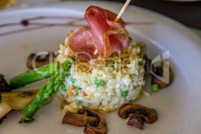 Risotto with mushrooms, fresh herbs and parmesan ham.
