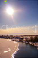 river in winter with sun