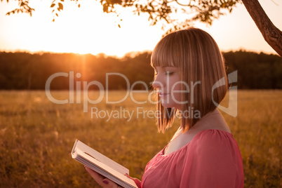 Girl with a book on nature