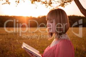 Girl with a book on nature
