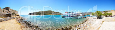 The motor yachts with tourists are near Spinalonga island, Greece