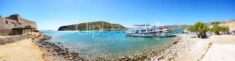 The motor yachts with tourists are near Spinalonga island, Greece