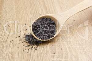 Poppy seeds in a wooden spoon