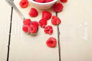 bunch of fresh raspberry on a bowl and white table