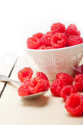 bunch of fresh raspberry on a bowl and white table