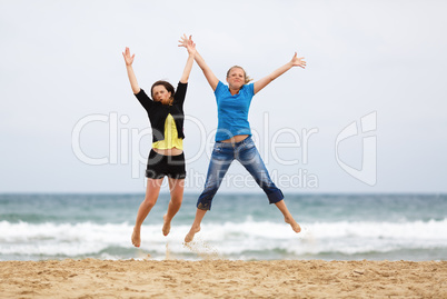 Two women jumping