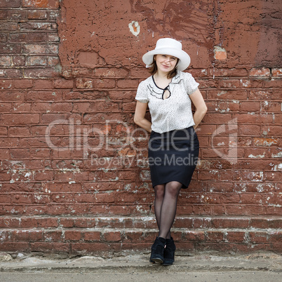 Woman on the brick wall background