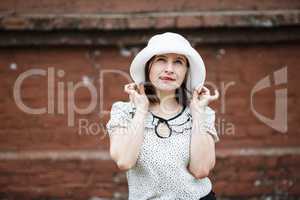 Woman in white hat showing tongue