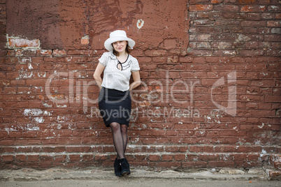 Woman on the brick wall background