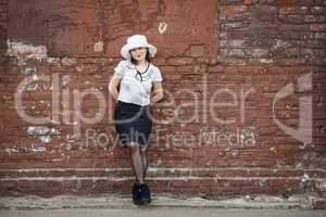 Woman on the brick wall background