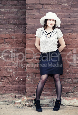 Woman and brick wall