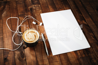 Letterhead, pen, headphones and coffee cup