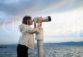 Woman look in pay binocular