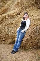 Woman on the background of haystacks